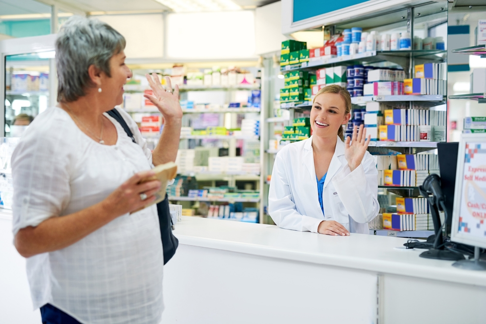 customer waving to pharmacist