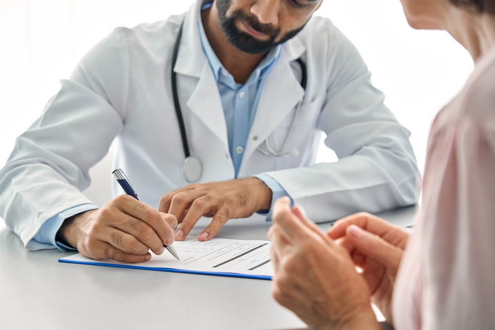 pharmacist reviewing patient history during wellness consultation